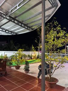 a pavilion with potted trees on a patio at Mộc Lan resort in Phú Quốc +16 photos