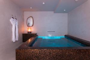 a bathroom with a jacuzzi tub in a room at The One Alma Paris in Paris
