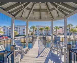 a gazebo with blue chairs on a deck at Peaceful Retreat on the Intracoastal Waterway! Myrtle Beach - Indoor Pool in Myrtle Beach