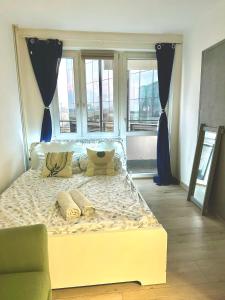 a large bed in a room with windows at Central Warsaw Gem in Warsaw