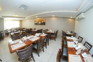 a dining room with wooden tables and chairs at Saionara Hotel in Rio de Janeiro