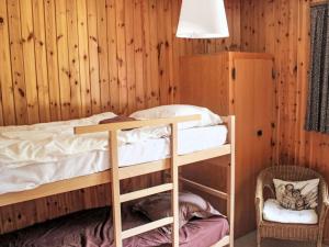 a bedroom with a bunk bed and a chair at Chalet L'Alpage by Interhome in Ovronnaz +13 photos