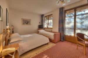 Postel nebo postele na pokoji v ubytování Hotel Waldheim Belvedere