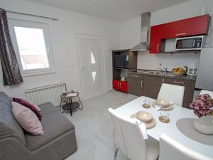 a living room and kitchen with a couch and a table at Apartment Aquanur-5 by Interhome in Sovlje