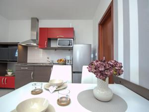 a kitchen with a table with a vase of flowers at Apartment Aquanur-5 by Interhome in Sovlje +25 photos