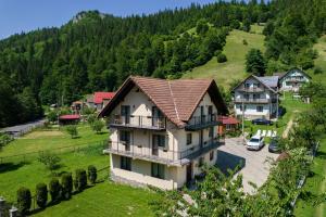 an aerial view of a house on a hill at Transylvania Hut in Moieciu de Sus +26 photos