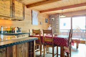 a kitchen with a table with a red and white table cloth at #AH15 Les Chalets d'Ysalis in LʼHuez