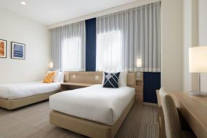 Postel nebo postele na pokoji v ubytování Four Points Flex by Sheraton Osaka Kitahama