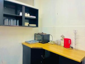 a kitchen with a counter with a microwave on it at Stay Inn Budget Rooms in Phalaborwa