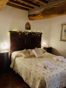 a bedroom with a large bed with two towels on it at Country Home Marsciano in Marsciano