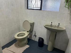 a bathroom with a toilet and a sink at Stay Inn Budget Rooms in Phalaborwa