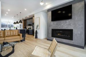 a living room with a couch and a fireplace at The Luxury Black Rose Chalet at The Blue Mountains for 20 in Blue Mountains