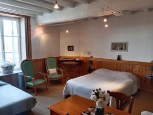 a bedroom with two beds and a dog sitting on a table at Chambres d'hotes la Fromagerie du Relais Postal Royal in Colombey-les-deux-Églises