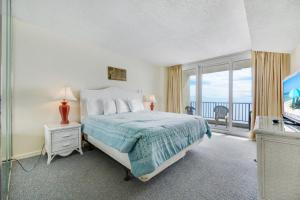 a bedroom with a bed with a view of the ocean at Oceanfront Oasis 1003 in Abbeyville +16 photos