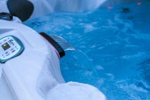 a bottle of water in a swimming pool at White Rose Chalet at Blue Mountains for 20 w Hot Tub in Blue Mountains