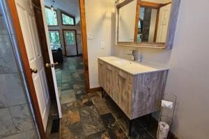 a bathroom with a sink and a mirror at All-Season 8BR Vacation Chalet in Blue Mountains +28 photos
