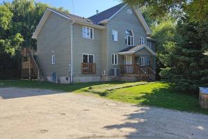 a large house with a driveway in front of it at All-Season 8BR Vacation Chalet in Blue Mountains