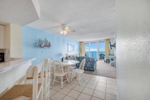 a living room and dining room with a table and chairs at Oceanfront Oasis 1002 in Abbeyville