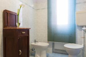 a bathroom with a toilet and a sink at Hotel Eden in Arenzano +5 photos