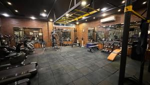 a gym with a lot of treadmills and machines at Al-Amaari Gardens Compound 3091 in Irbid