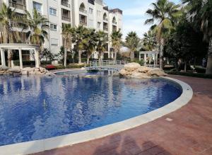 a large swimming pool in front of a building at Al-Amaari Gardens Compound 3091 in Irbid