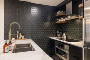 a kitchen with a sink and a counter top at Whistler Village 2BR, Sleeps 6, Air Con, Free Parking in Whistler +48 photos