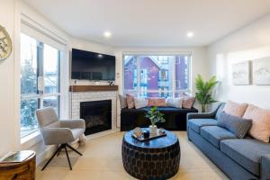 a living room with a couch and a fireplace at Whistler Village 2BR, Sleeps 6, Air Con, Free Parking in Whistler