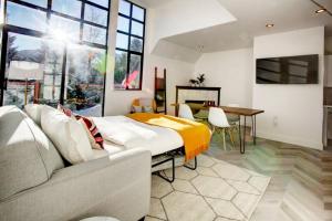 a bedroom with a bed and a table and a couch at Whistler Village 1BR, Sleeps 4, Pool, Hot Tub & Near Shops in Whistler