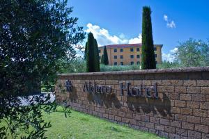 a brick wall with a sign that reads native hotel at Aldero Hotel in Civita Castellana