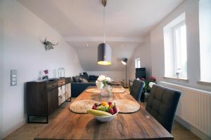 a dining room table with a bowl of fruit on it at DesignLodge Apartments in Bad Sobernheim