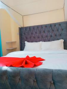 a red bow on top of a bed at Vee's 1br Apartment at Lower Section 58 with Lakeviews in Nakuru