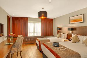 a hotel room with two beds and a desk at Glenroyal Hotel in Maynooth +37 photos
