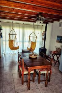 a dining room with a wooden table and chairs at Serendipia Santa Ana in Santa Ana