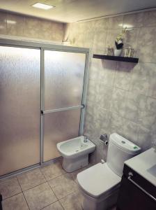 a bathroom with a shower and a toilet and a sink at Serendipia Santa Ana in Santa Ana +30 photos