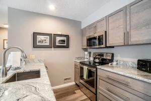 a kitchen with stainless steel appliances and wooden cabinets at Tee Time on Valleyway Drive in Traverse City +43 photos
