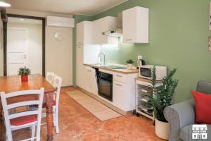 a small kitchen and dining room with a table at CASA DEL LAGO by Design Studio in Bellano