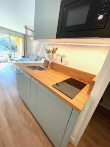 a kitchen with a counter with a sink and a microwave at Splendid Studio With Swimming Pool Next To Monaco in Beausoleil