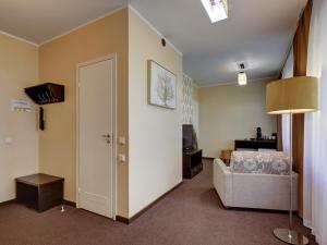 a living room with a couch and a door at Narva-Jõesuu Medical Spa in Narva-Jõesuu