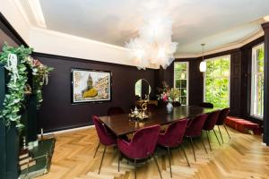 a dining room with a table and red chairs at Hillthorpe Estate - 14 Bed Manor House with Hot Tubs and Secluded Gardens in East Hardwick