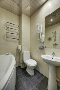 a bathroom with a toilet and a sink at Narva-Jõesuu Medical Spa in Narva-Jõesuu