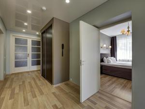 a room with a bedroom with a bed and a sliding door at Narva-Jõesuu Medical Spa in Narva-Jõesuu
