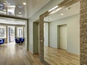 an empty lobby with blue chairs and a brick wall at Narva-Jõesuu Medical Spa in Narva-Jõesuu