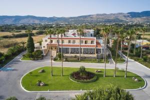 an aerial view of a building with palm trees at Atlantica Thalassa Hotel in Kos Town