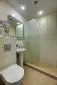 a bathroom with a toilet and a shower and a sink at Narva-Jõesuu Medical Spa in Narva-Jõesuu
