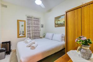 a bedroom with a bed with towels on it at Cosy and Spacious 3BR Apt in Bugibba's heart by 360 Estates in St Paul's Bay