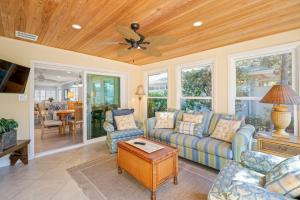 een woonkamer met een bank en een plafondventilator bij Siesta Villa Whispering Palms in Siesta Key
