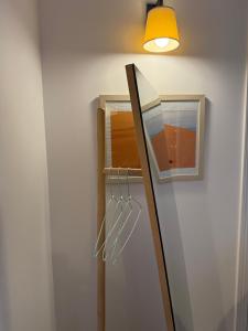 a mirror on a wall next to a light at Château Montagne "Terre de Sienne" in Saint-Philippe-dʼAiguille +6 photos