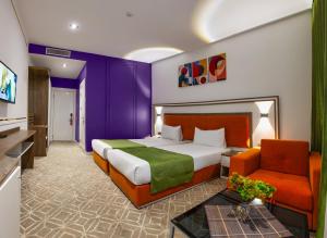 a hotel room with a bed and a couch at ALBA HOTEL & SPA in Baku