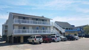 a building with cars parked in a parking lot at Atlantic Breeze Motel & Apartments in Ocean City