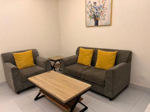 a living room with two couches and a coffee table at ريزا الفندقية Reeza Suites in Al Khobar